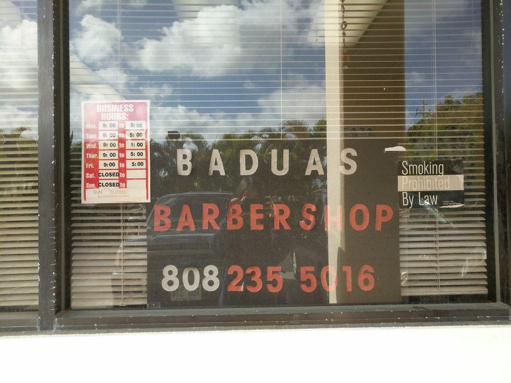 The front window of Badua's Barbershop on William Henry Road